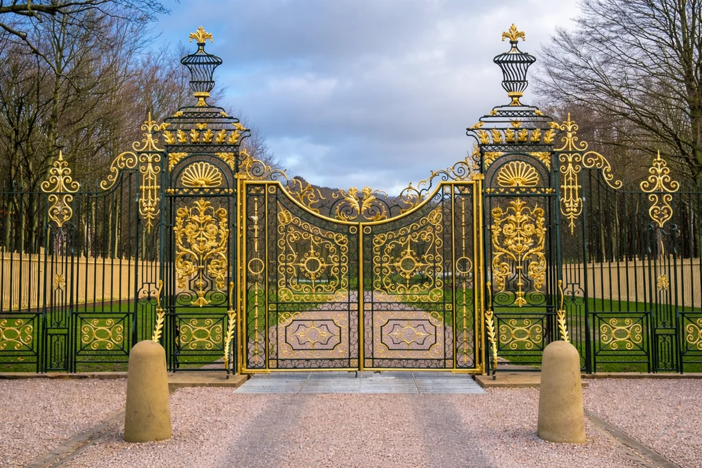 The Golden Gates at Chatsworth framed by stone piers and trees