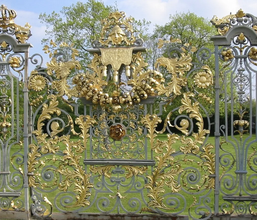 Gilded crests and scrolling ironwork on the Hampton Court garden screen